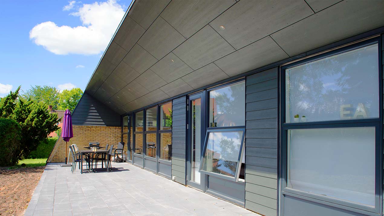 Hus med tagudhæng lavet af fibercement facadeplader